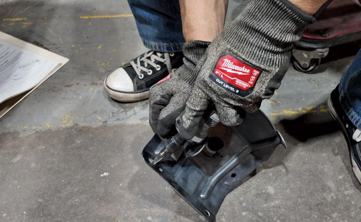 Die grinder used to slot mounting holes for Camaro hood latch